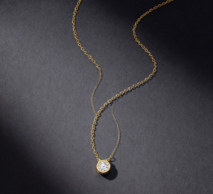 A necklace featuring 0.15-carat lab-grown diamonds bezel-set in 18K gold plated with sterling silver.